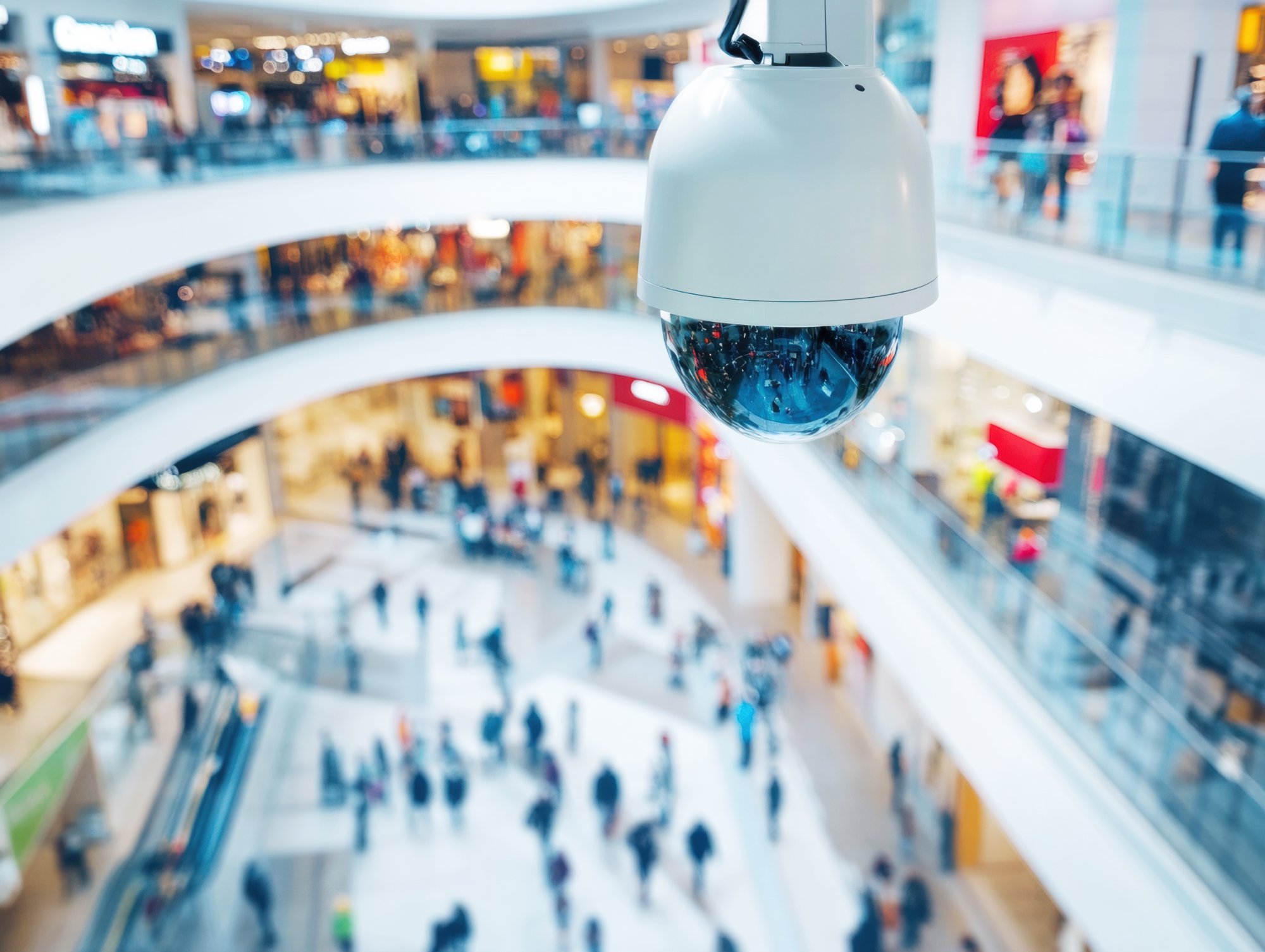 CCTV surveillance camera monitoring a busy commercial shopping centre